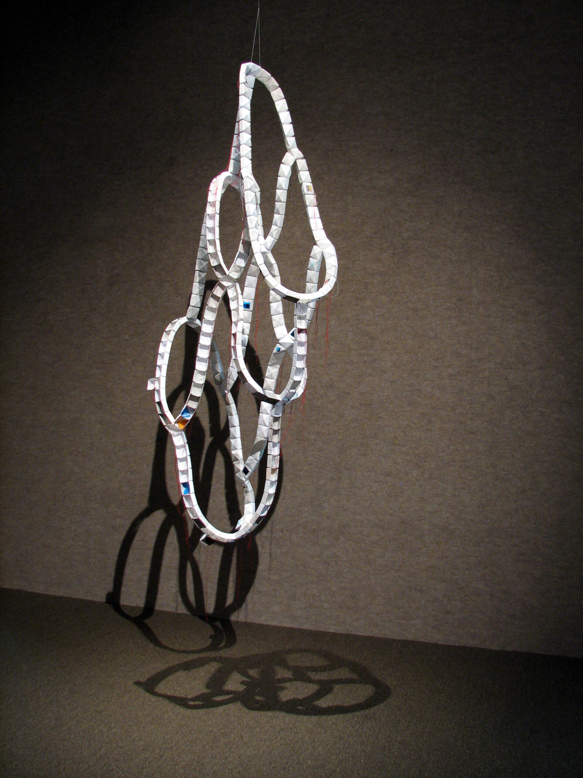 A sagging cylindrical paper artwork hung from the ceiling by artist Joanna White.