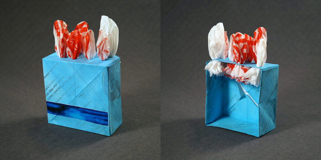 Two views of a small sculpture by artist Joanna White, featuring paper boxes and paint.