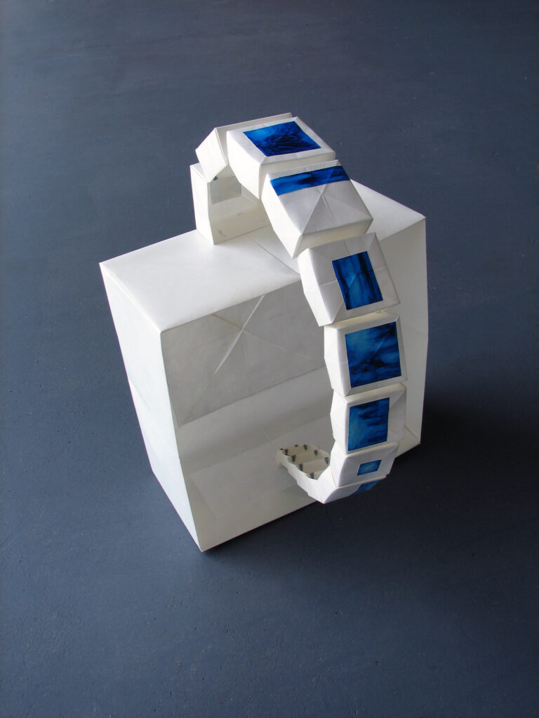 Back view of sculpture by Joanna White, featuring a vellum box with a loop of smaller boxes painted with blue monochromatic oil paint.