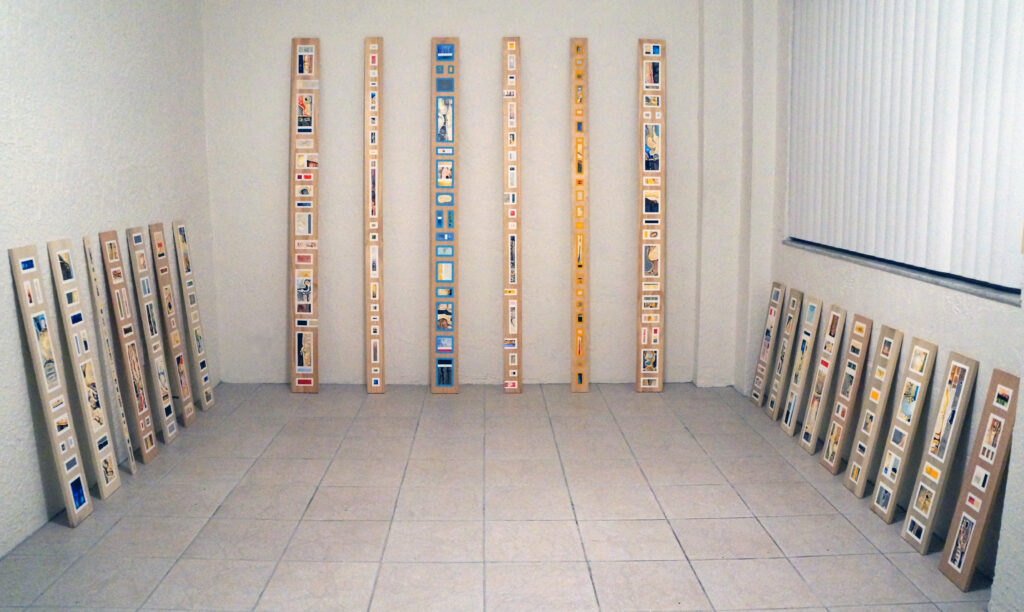 A room full of long narrow paintings on wooden boards by artist Joanna White.